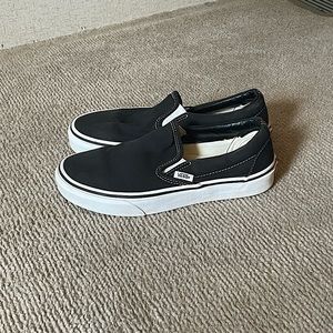 Black and white Slip-on Vans.